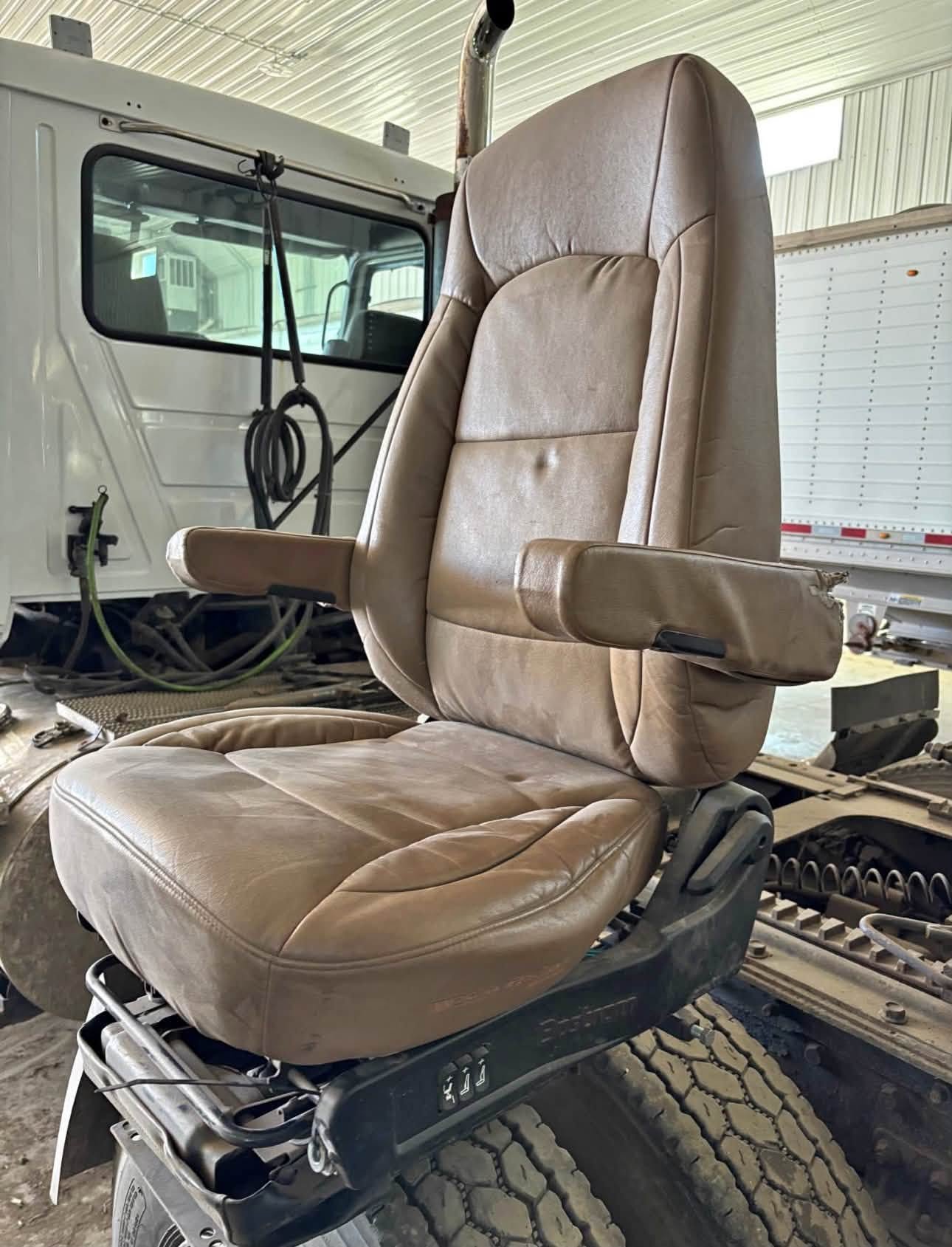 Bostrom Wide Ride seat, Bostrom air ride seat, Bostrom truck seat, Bostrom Wide Ride air seat, tan leather truck seat, truck air ride seat, used Bostrom seat, Bostrom seat for sale, used truck seat, replacement truck seat, semi truck air ride seat, heavy duty truck seat, commercial truck seat, Bostrom Wide Ride replacement seat, tan truck seat, air suspension truck seat.